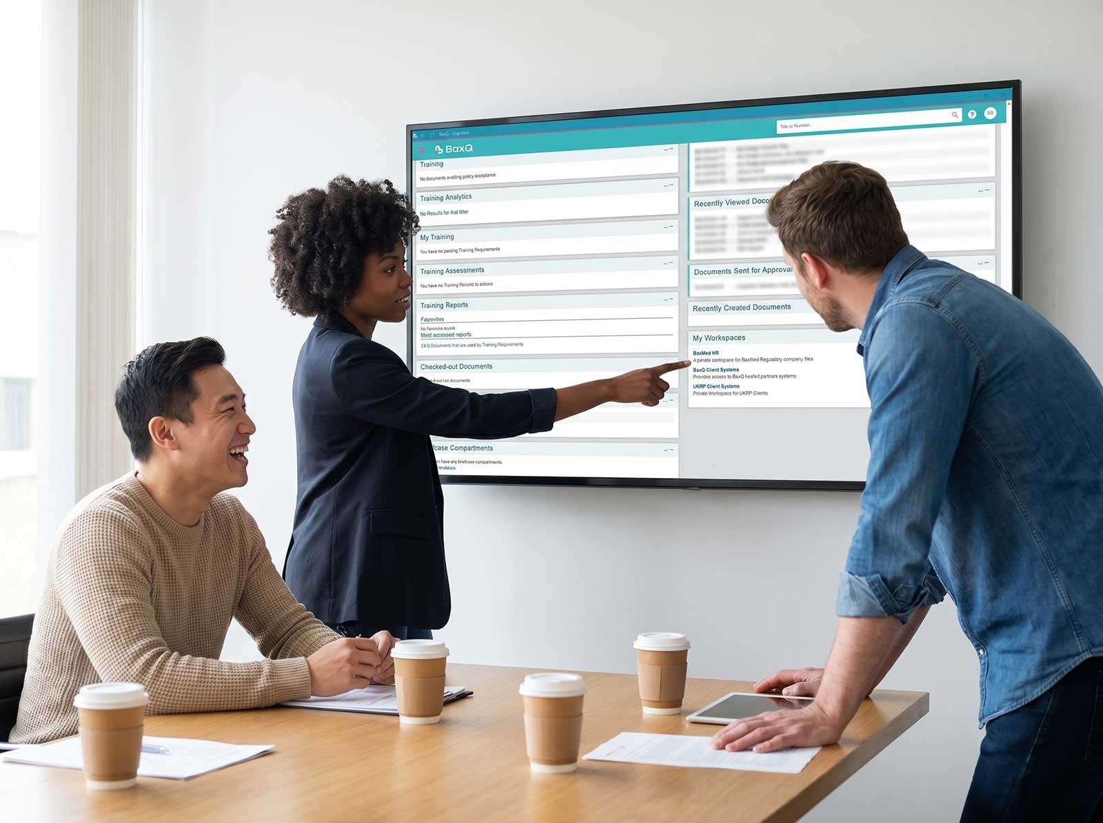 Three colleagues reviewing BaxQ regulatory document management dashboard on a wall-mounted screen during a compliance team meeting, BaxMed